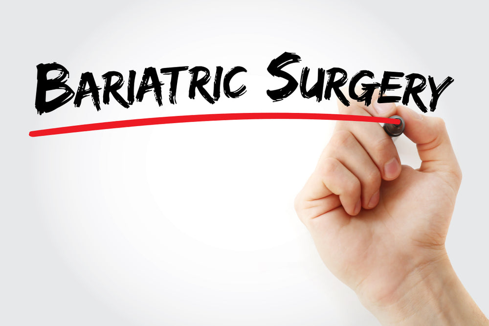 A hand is writing "Bariatric Surgery" in bold, black letters, with a red underline, against a plain white background, emphasizing the topic of weight loss surgery.