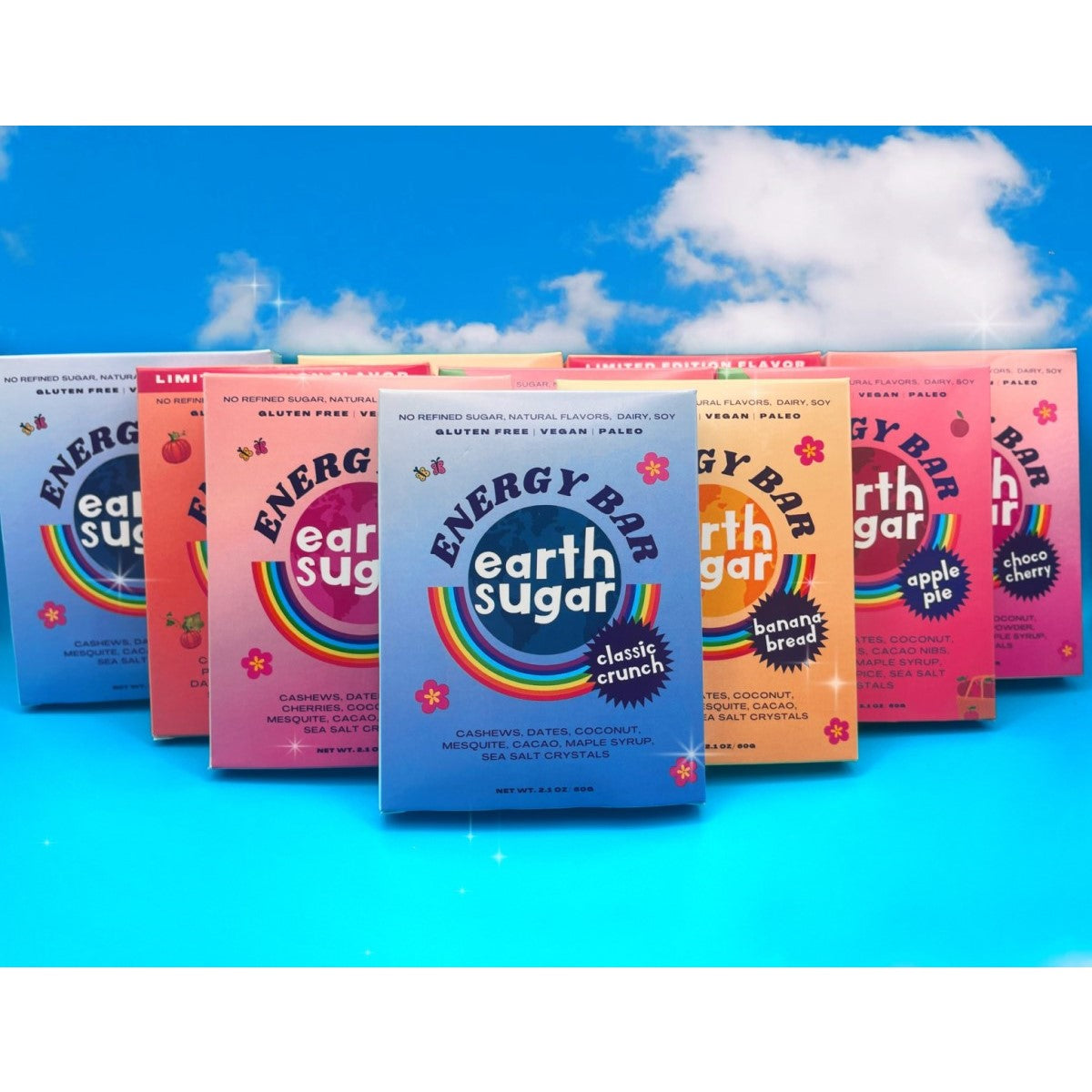 Seven colorful boxes of Earth Sugar energy bars are displayed against a bright blue background, showcasing flavors like classic crunch, banana bread, and apple pie, emphasizing their organic, gluten-free, and vegan qualities.