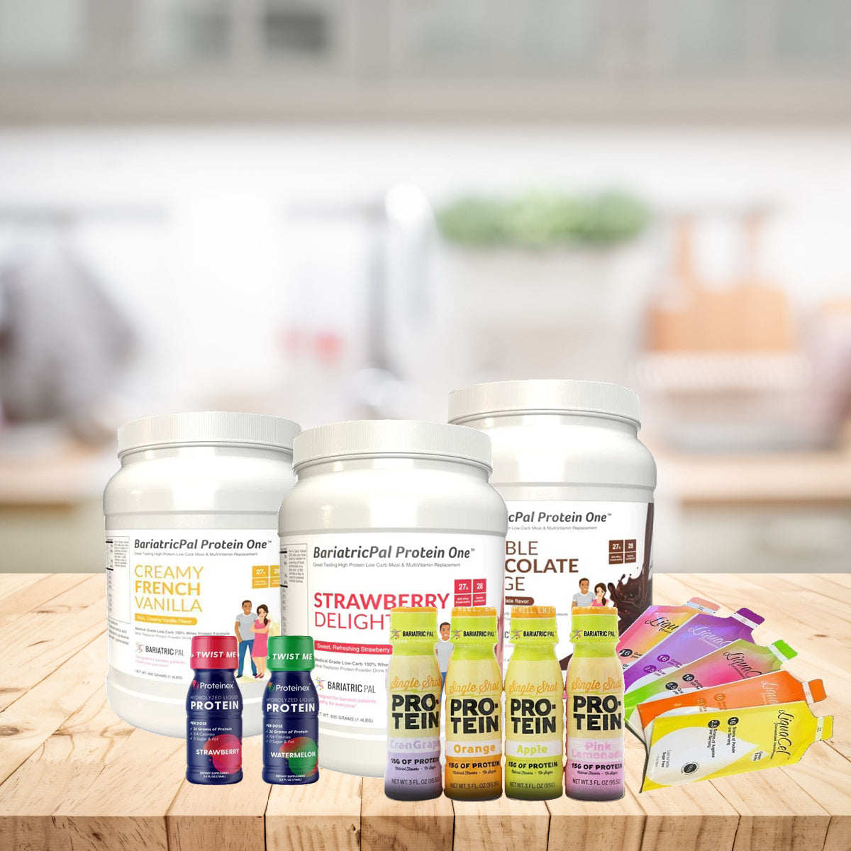 Three tubs of BariatricPal Protein One in flavors like Creamy French Vanilla and Strawberry Delight sit on a wooden table, surrounded by colorful protein drink packets and bottles in a bright kitchen setting.