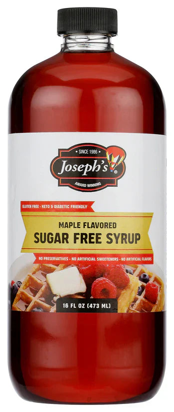 A clear bottle of Joseph's maple-flavored sugar-free syrup, labeled gluten-free and diabetic-friendly, showcases a colorful image of waffles topped with berries on the front.