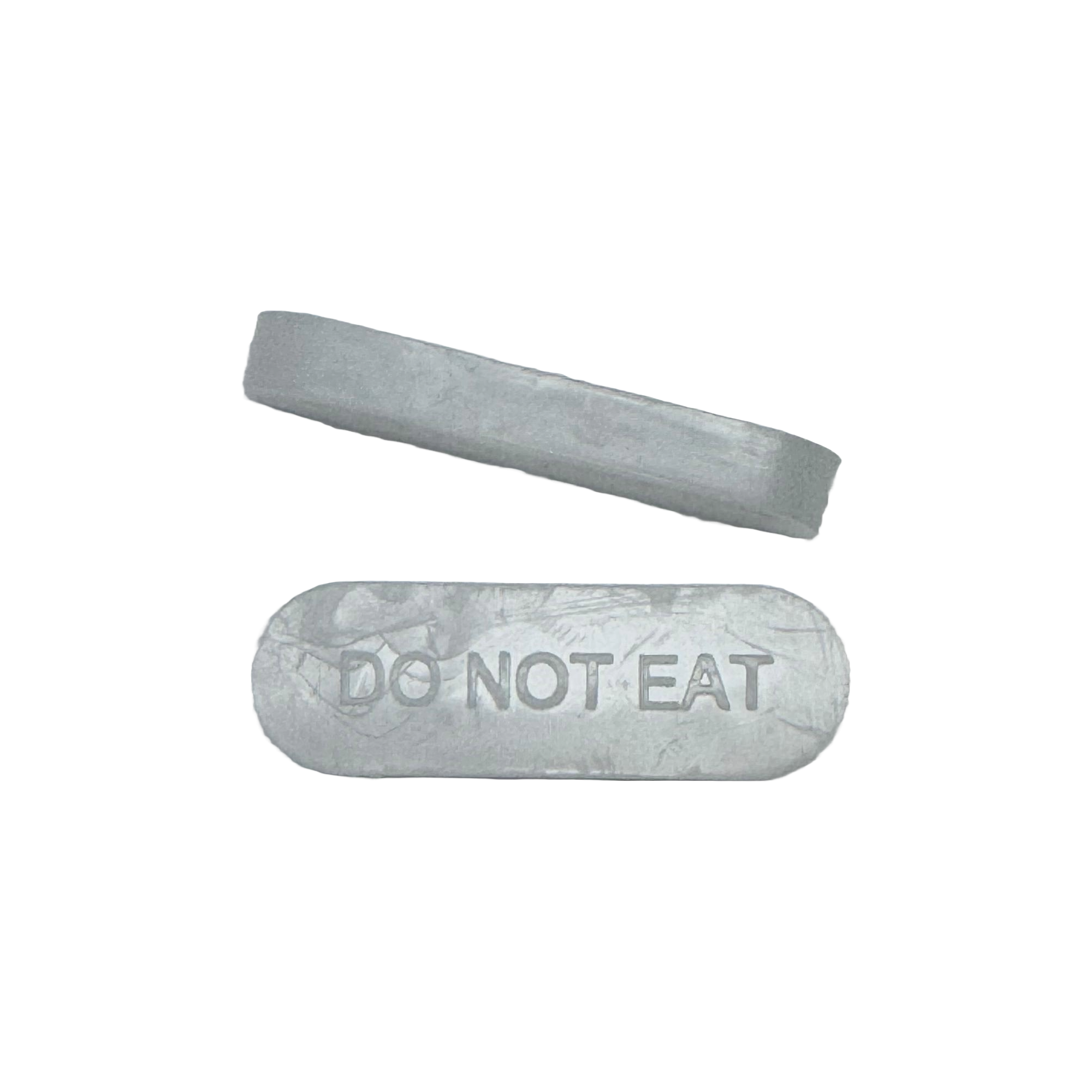Two gray silica gel packets are shown, one rectangular with the text "DO NOT EAT" clearly visible, and a smaller, elongated packet positioned above it.