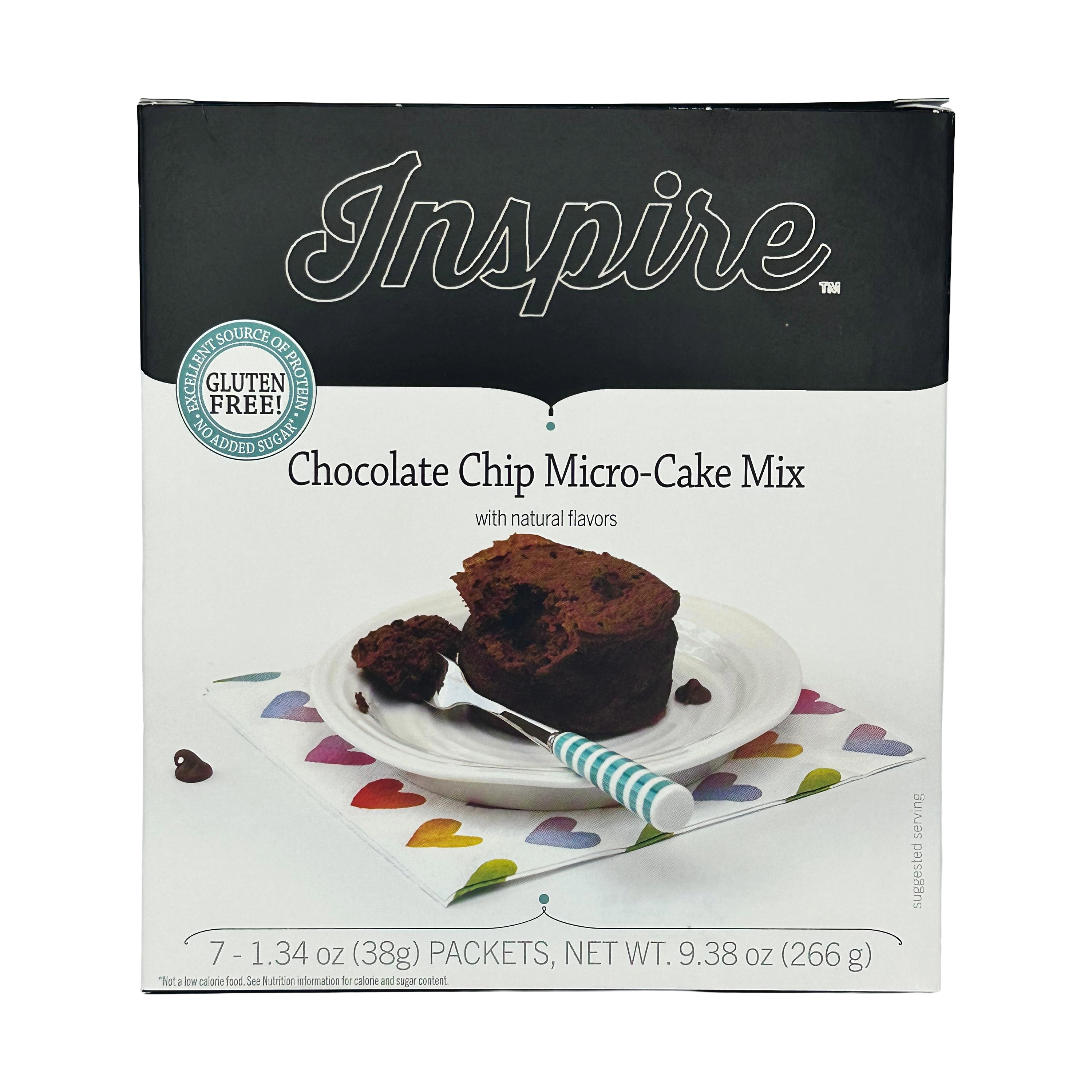 A box of Inspire Chocolate Chip Micro-Cake Mix features a slice of cake on a white plate with a fork, set on a colorful heart-patterned napkin, highlighting its gluten-free and natural flavors.