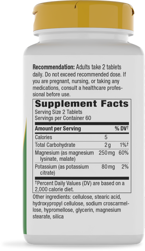A white supplement bottle with a yellow cap displays nutritional information, including serving size, calories, and ingredients, emphasizing daily dosage recommendations for adults.