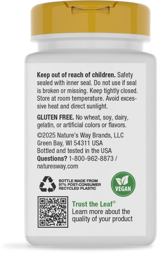 A white bottle with a gold cap contains product safety information, including storage instructions, allergen details, and a vegan label, set against a plain background.