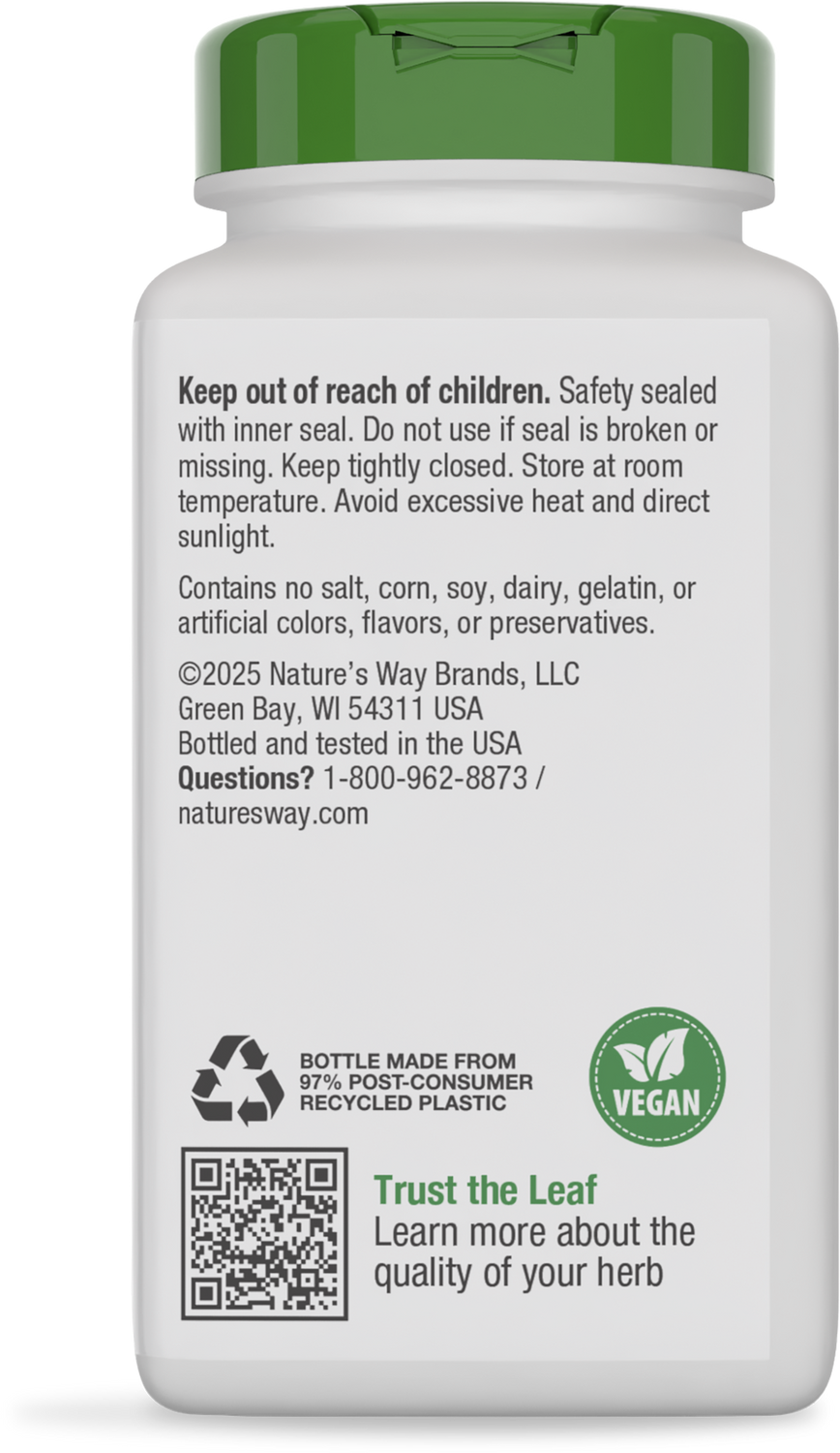 A white bottle with a green cap displays safety instructions, ingredient information, and recycling details, indicating it is vegan and made from recycled plastic.