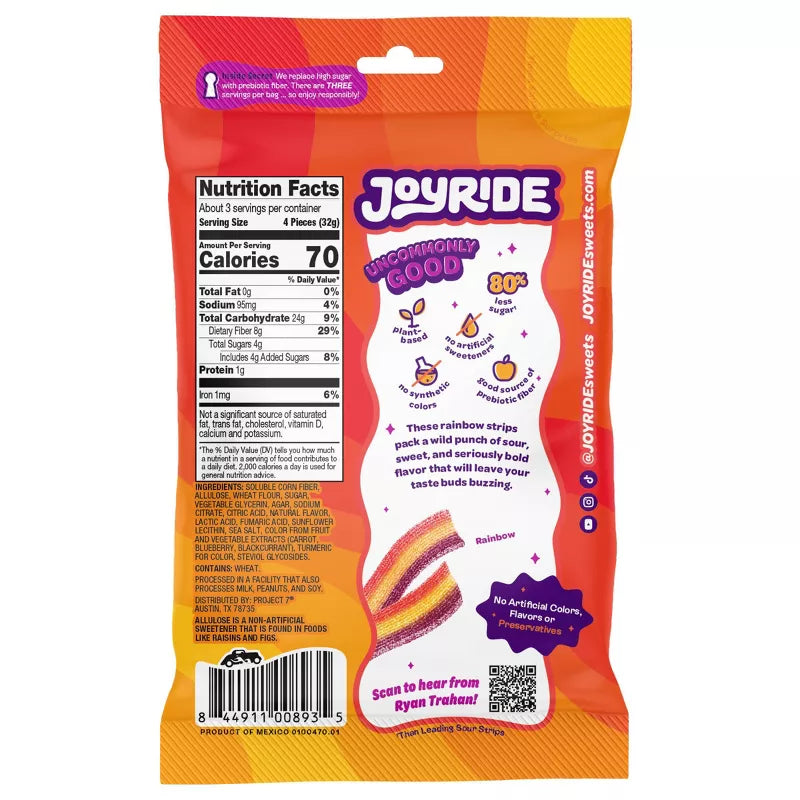 A colorful snack bag of Joyride rainbow strips features nutrition facts, bold text stating "Uncommonly Good," and highlights about reduced sugar and natural ingredients, with a playful design.