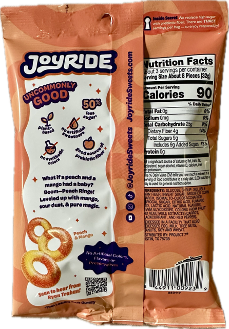 A peach and mango-flavored gummy snack package features a playful design, nutritional information, and a QR code for more details, highlighting its low sugar content and natural ingredients.