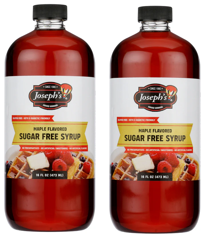 Two bottles of Joseph's maple flavored sugar-free syrup, each labeled as gluten-free, keto, and diabetic-friendly, displayed with a serving suggestion of waffles topped with berries and butter.