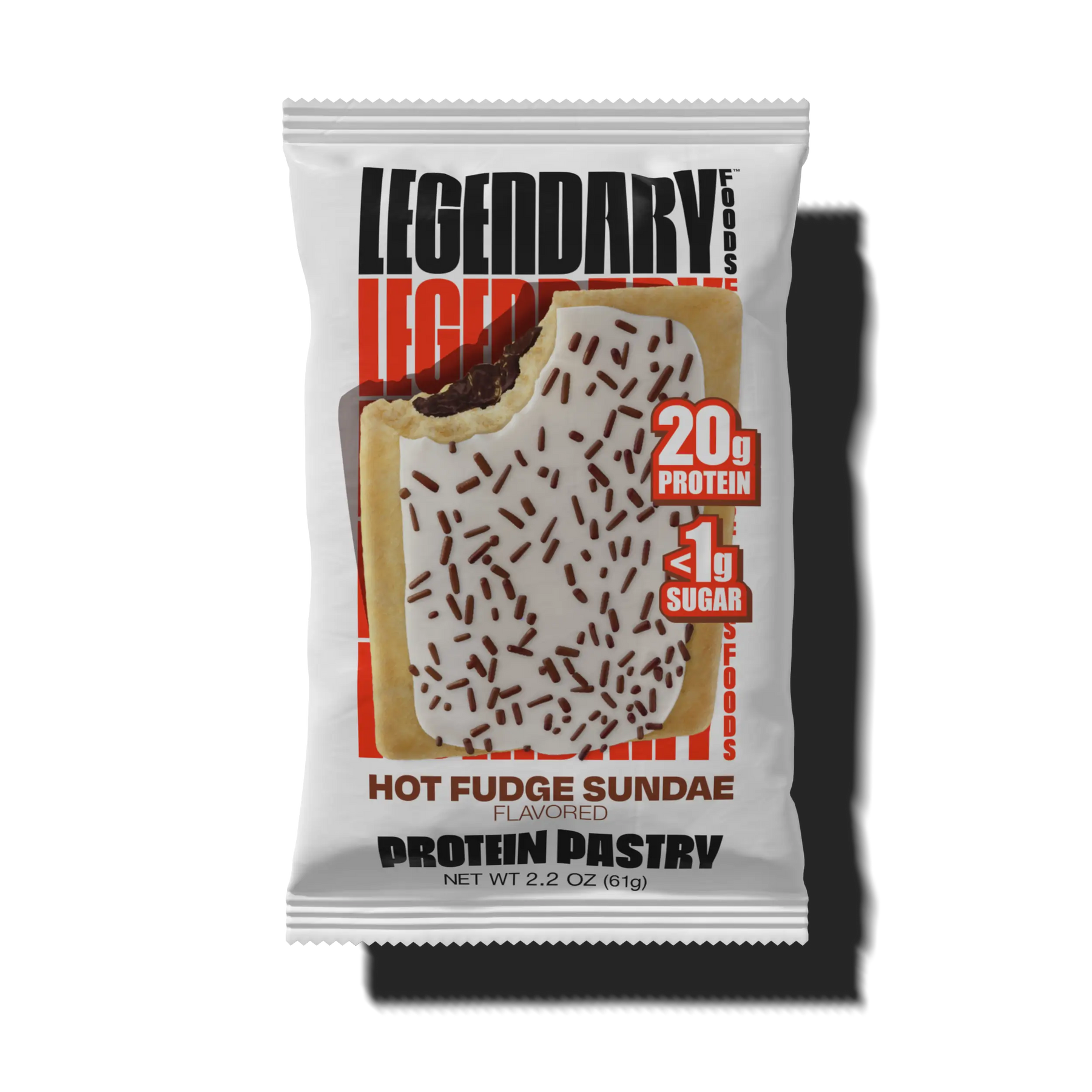 A partially bitten protein pastry with a hot fudge sundae flavor, topped with white icing and chocolate sprinkles, is displayed in its packaging featuring nutritional information.
