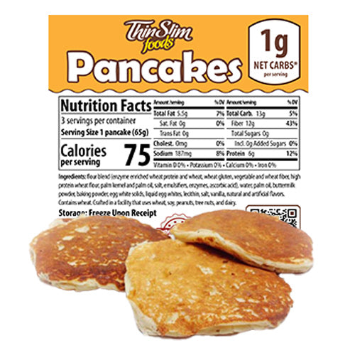 Pancakes are stacked on a surface in front of a nutrition label highlighting low carb content, with details on serving size, calories, and other nutritional information prominently displayed above.