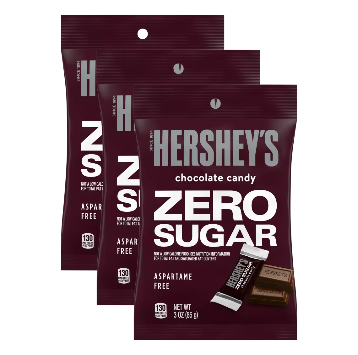 Three bags of Hershey's Zero Sugar chocolate candy are displayed, featuring bold text on a maroon background, highlighting that the product is aspartame-free and contains 130 calories per serving.