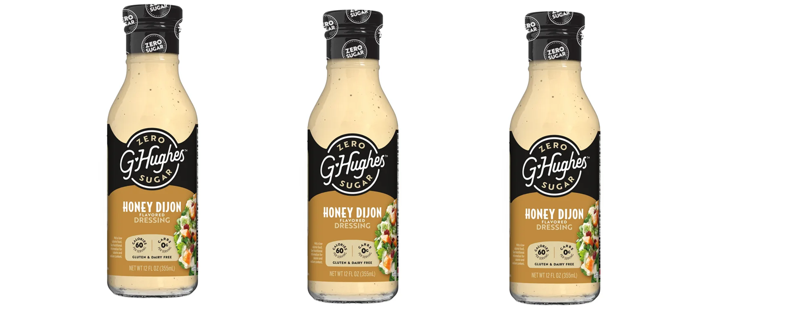 Three bottles of G. Hughes Honey Dijon flavored dressing are displayed side by side, each featuring a clear label with a black and gold design, highlighting its zero sugar, gluten-free, and dairy-free attributes.