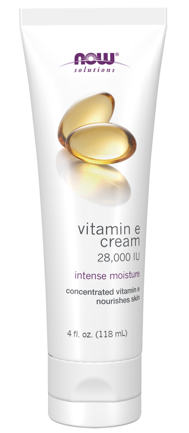 A white tube of NOW Solutions Vitamin E cream, labeled "28,000 IU," displays a glossy image of vitamin E capsules and highlights "intense moisture" for skin nourishment.
