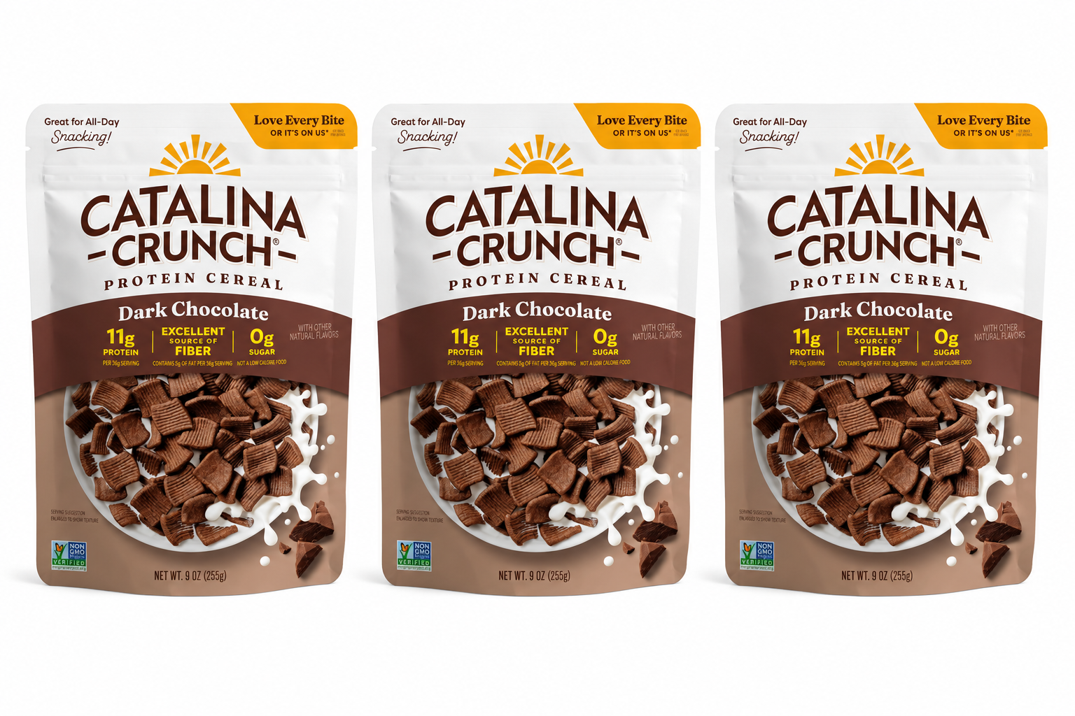 Three bags of Catalina Crunch Dark Chocolate protein cereal are displayed, showcasing the product's branding, nutritional information, and a close-up of the crunchy chocolate pieces inside.