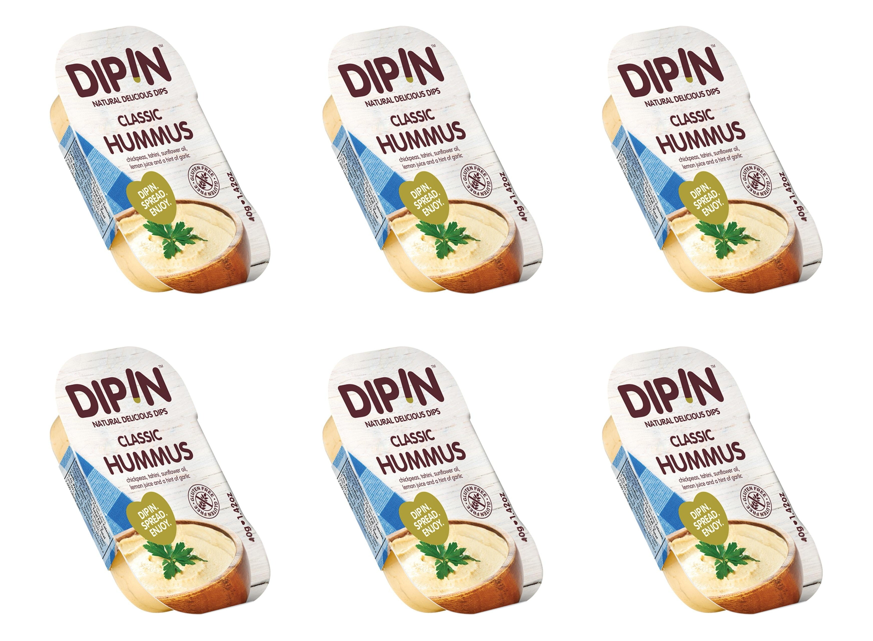 Six containers of DIP IN Classic Hummus are displayed, each featuring a light-colored hummus dip topped with a sprig of parsley and labeled with the product name and description.