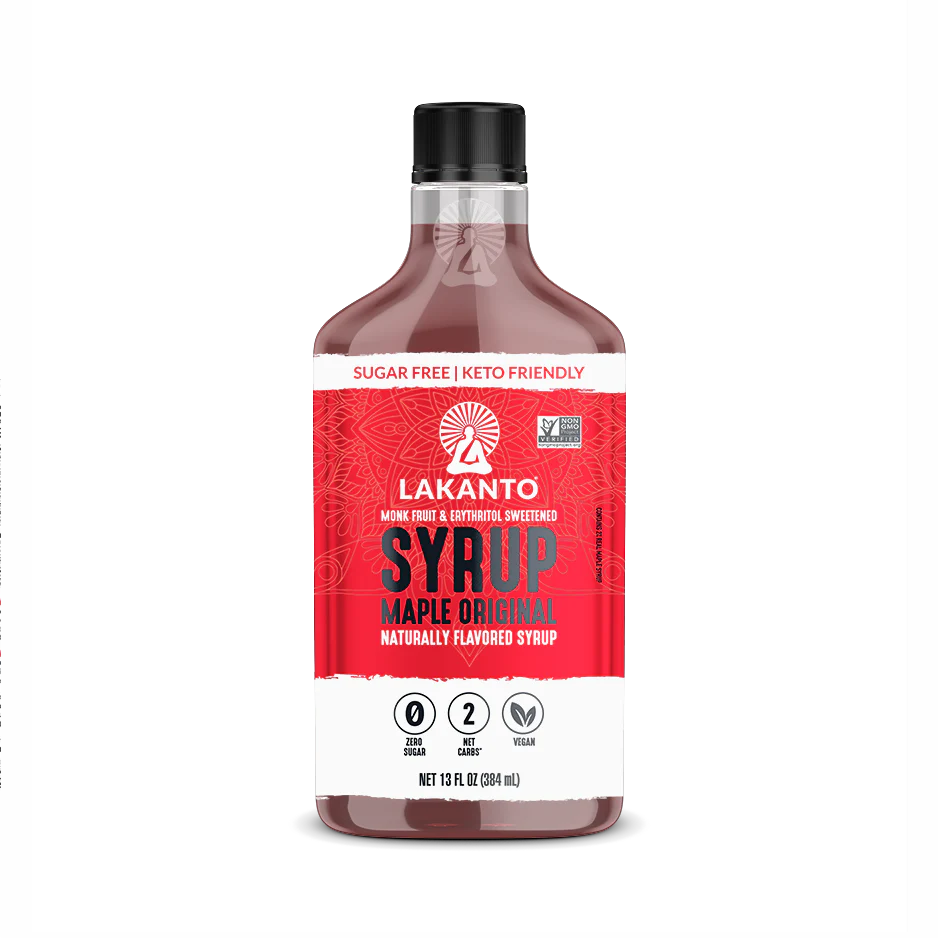 A clear plastic bottle of Lakanto Maple Original Syrup, labeled as sugar-free and keto-friendly, features a red design and highlights that it is sweetened with monk fruit and erythritol.