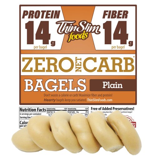 A package of Thin Slim Foods plain bagels is displayed, featuring a label that highlights 14 grams of protein and fiber per bagel, with the claim of zero net carbs.