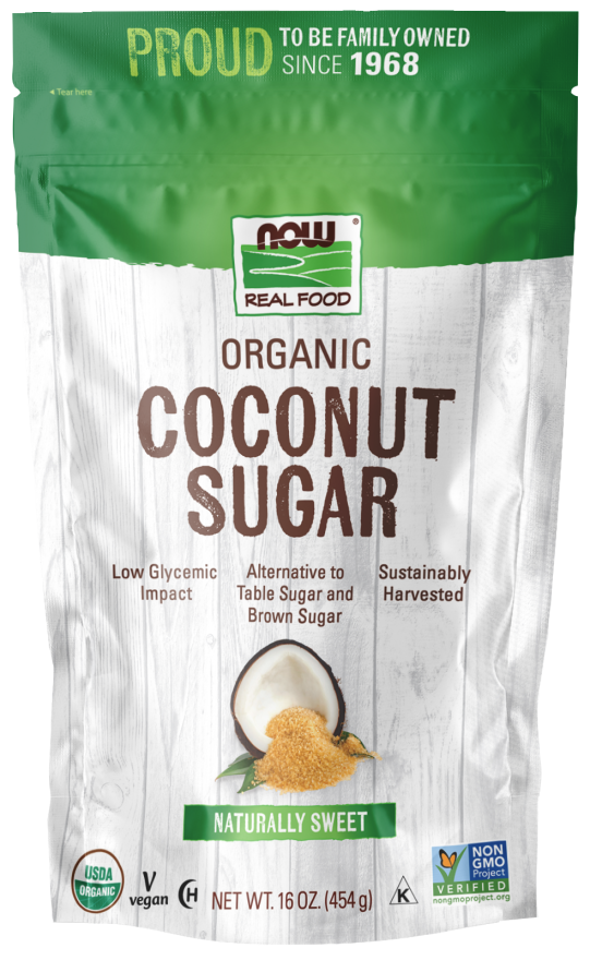 A green and white bag of NOW Real Food Organic Coconut Sugar features a coconut image and highlights its low glycemic impact, vegan status, and sustainable harvesting, with a net weight of 16 ounces.