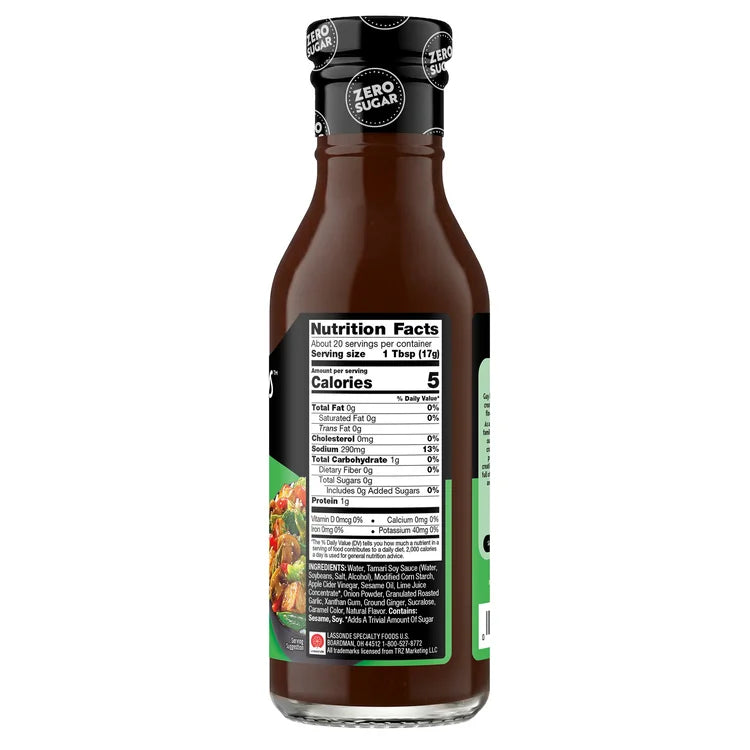 A brown bottle of zero-sugar sauce displays nutrition facts and ingredients on its label, highlighting low calories and serving size, set against a plain background.
