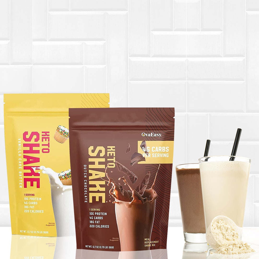 Two packets of OvaEasy Keto Protein Shakes, one vanilla cake batter and one Dutch chocolate, are displayed alongside two glasses of shakes and a scoop of powder on a white tiled background.
