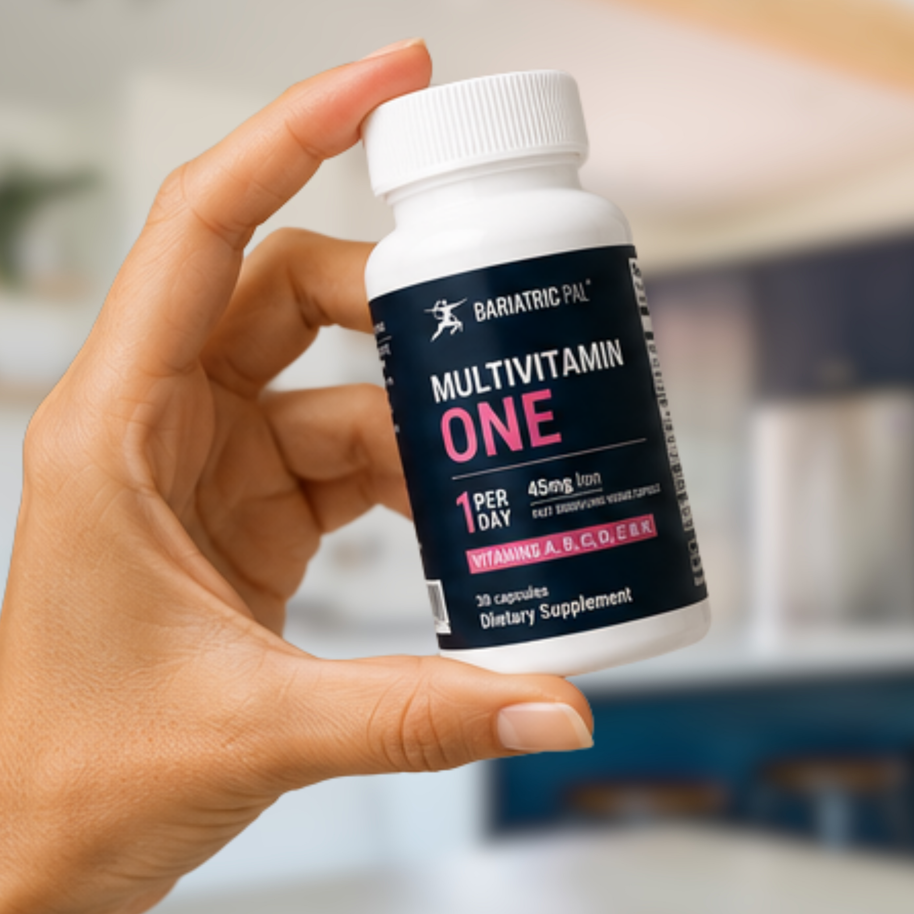 A hand holds a bottle of Bariatric Pal Multivitamin One, labeled for daily use with vitamins A, B, C, D, E, and K, set against a softly blurred kitchen background.