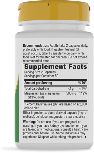 A white bottle of magnesium supplement capsules with a yellow cap displays dosage recommendations, serving facts, and a warning label on its side, set against a plain background.