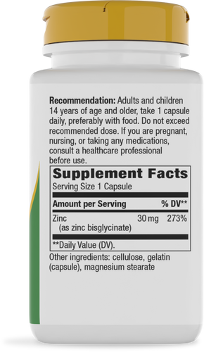 A white supplement bottle with a yellow cap displays dosage recommendations and nutritional information, highlighting zinc content and ingredients for dietary use.