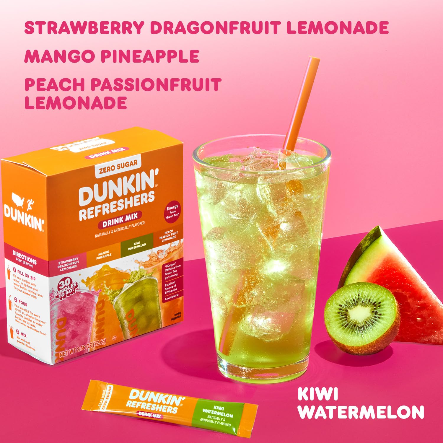 A glass of green Dunkin' Refreshers drink with ice and a straw is displayed next to a box of drink mix flavors, including Strawberry Dragonfruit Lemonade and Kiwi Watermelon, against a pink background.