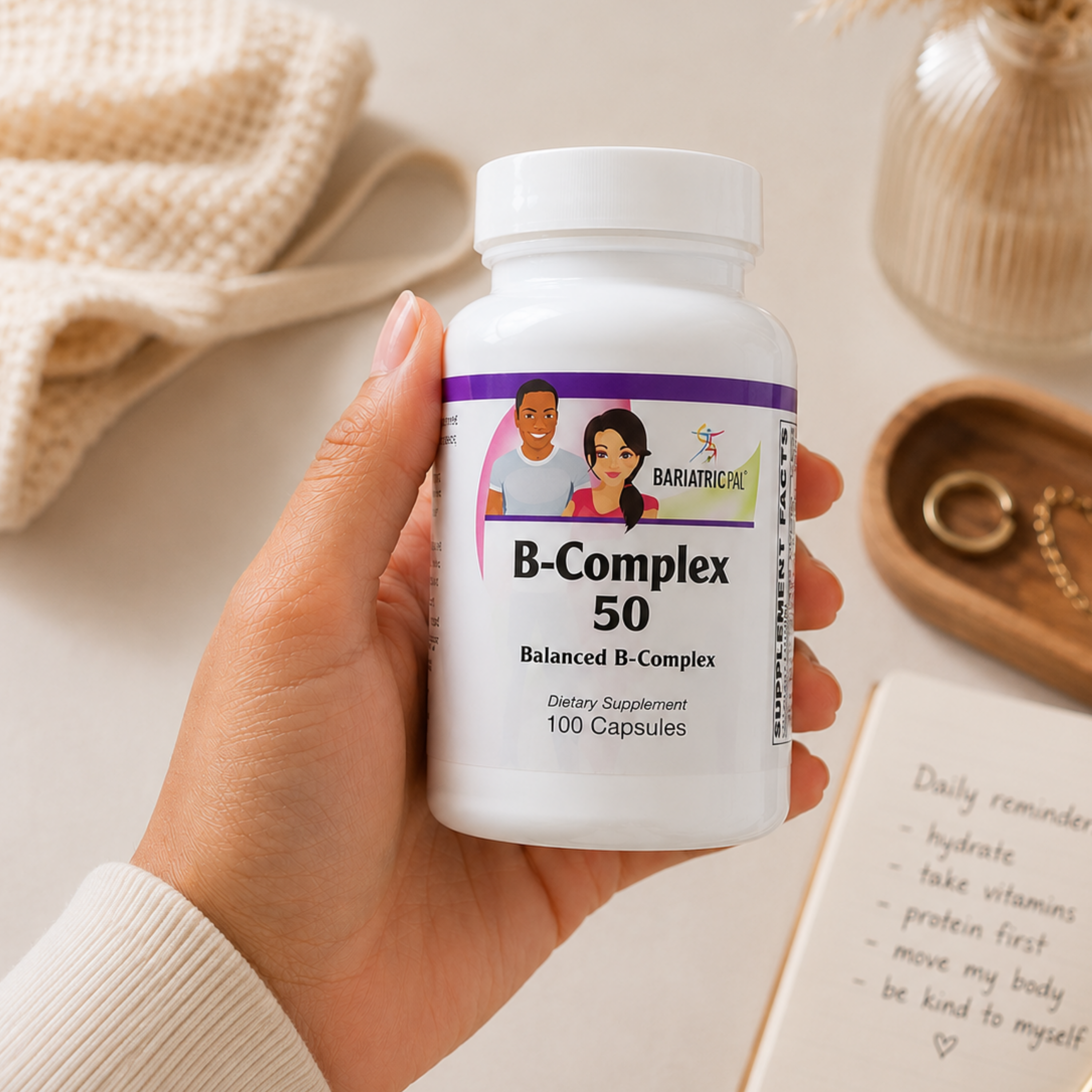 A hand holds a bottle of B-Complex 50 dietary supplement.