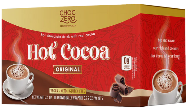 A box of Choc Zero Hot Cocoa mix features a steaming cup of hot chocolate with a swirl of cocoa, emphasizing its vegan, keto, and gluten-free qualities, with ten individually wrapped packets inside.