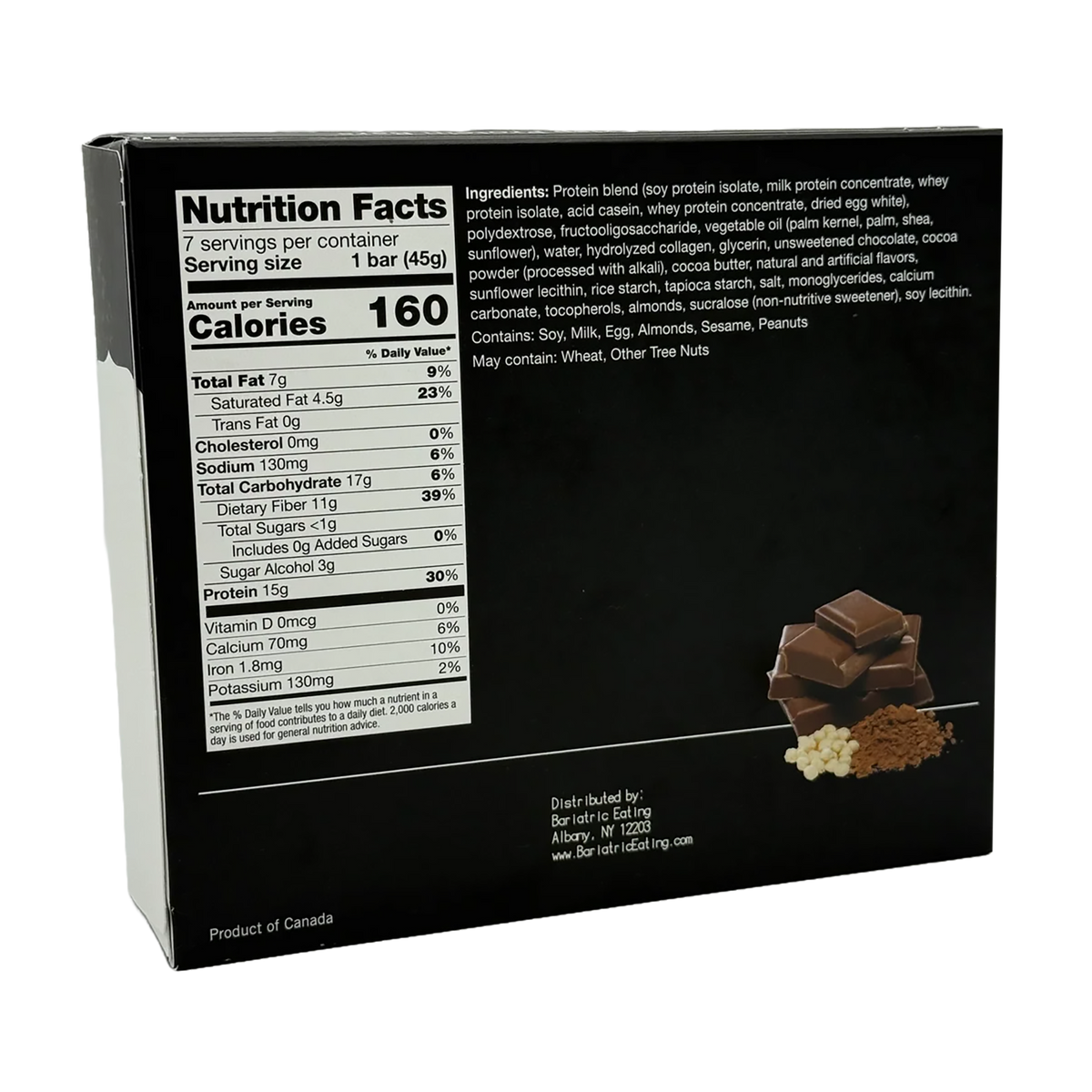 Woman holding a box of Inspire Low Carb Protein Fiber Bars – Chocolate Crisp in a kitchen.