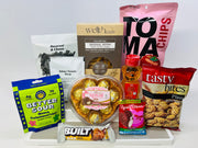 A variety of food products are displayed, including pasta, soup, snacks, and candy, arranged on a white background for an e-commerce product showcase.