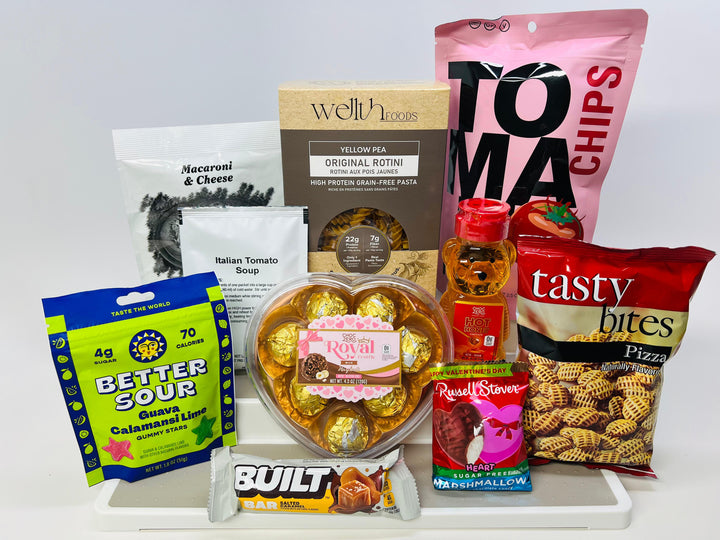 A variety of food products are displayed, including pasta, soup, snacks, and candy, arranged on a white background for an e-commerce product showcase.