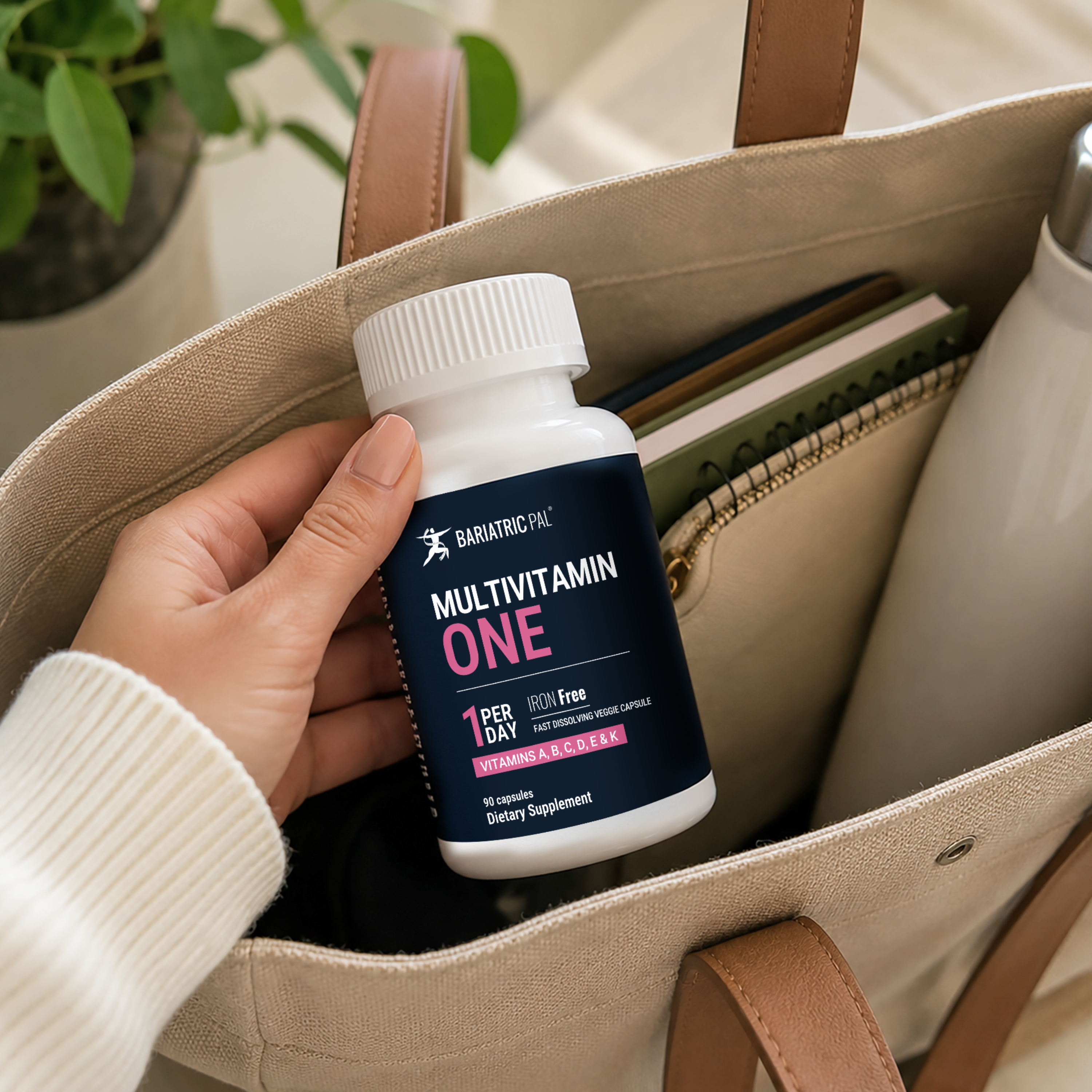 Woman holding BariatricPal multivitamin ONE Iron Free bottle. 