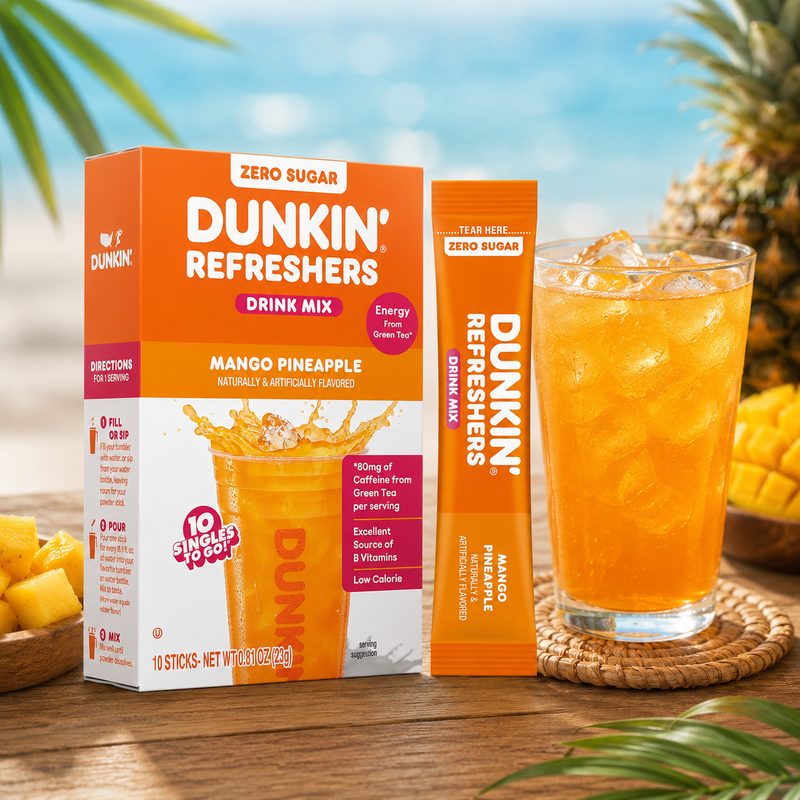 Dunkin' Refreshers Mango Pineapple drink mix packaging with a glass of the drink on a wooden surface.