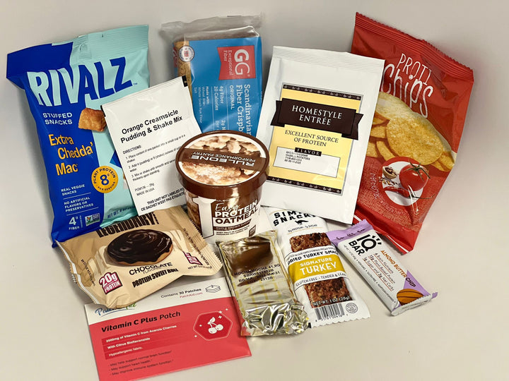 A variety of protein-rich snacks and meal options are displayed, including a packet of cheese-flavored snacks, pudding mix, protein bars, and chips, all arranged on a neutral background.
