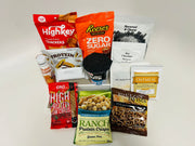 A variety of protein-rich food products, including crackers, pancakes, oatmeal, and snacks, are arranged on a white background, showcasing options for healthy eating.