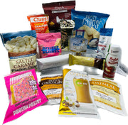 A variety of protein snacks and drinks, including chips, bars, and oatmeal packets, are arranged together on a white background, showcasing their packaging and nutritional information.