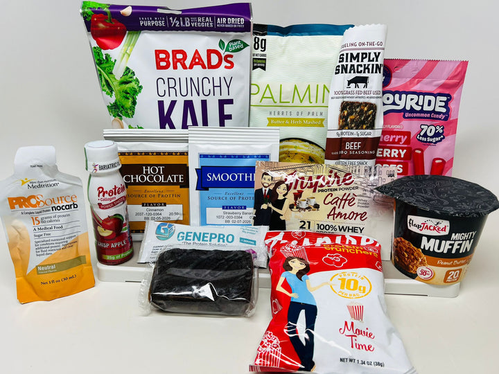 A variety of protein-rich snacks and drinks, including kale chips, beef jerky, protein powders, and a hot chocolate mix, are displayed on a white background, showcasing their packaging and nutritional information.