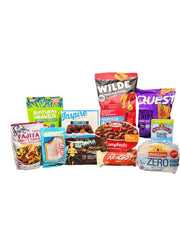 A variety of packaged food products, including protein snacks, sauces, and meal kits, are arranged on a white background, showcasing options like protein chips, fajita sauce, and ready-to-eat meals.