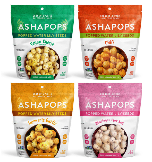 Four colorful bags of Ashapops popped water lily seeds are displayed, featuring flavors of Vegan Cheese, Chili, Turmeric Garlic, and Himalayan Pink Salt, each labeled with calorie information.