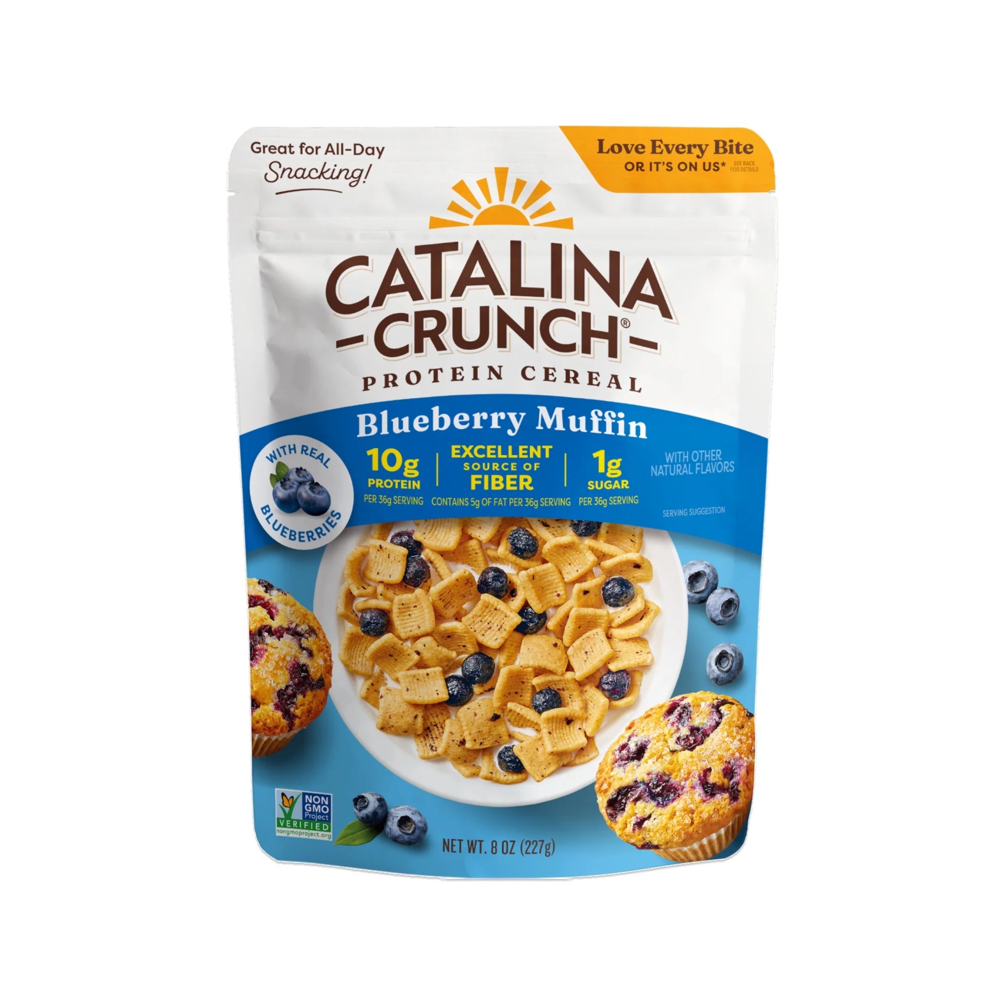 A bag of Catalina Crunch Blueberry Muffin protein cereal displays a bowl filled with cereal pieces and blueberries, alongside a blueberry muffin, highlighting its protein and fiber content.