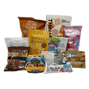 A variety of packaged snacks and protein products, including chips, bars, and drink mixes, are arranged against a black background, highlighting their nutritional benefits and flavors.