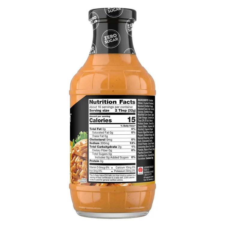 A clear bottle of zero sugar sauce displays nutrition facts and ingredients on its label, highlighting details like calories, serving size, and nutritional values for consumers.