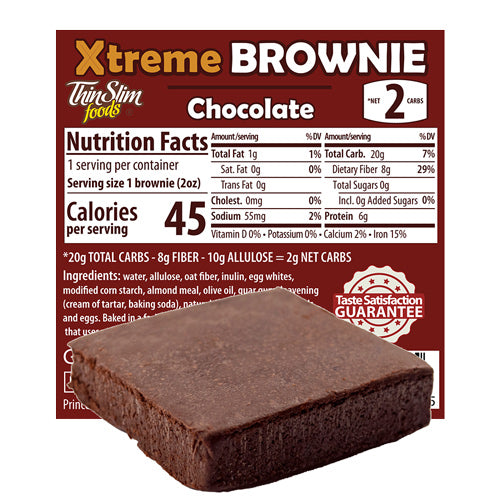A chocolate brownie sits in front of a nutrition facts label highlighting its low calorie count and high fiber content, indicating it contains only 2 net carbs per serving.