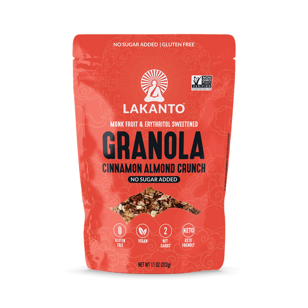 A red packaging of Lakanto granola labeled "Cinnamon Almond Crunch," highlighting features like "no sugar added," "gluten free," and "vegan," with a decorative design and nutritional information visible.