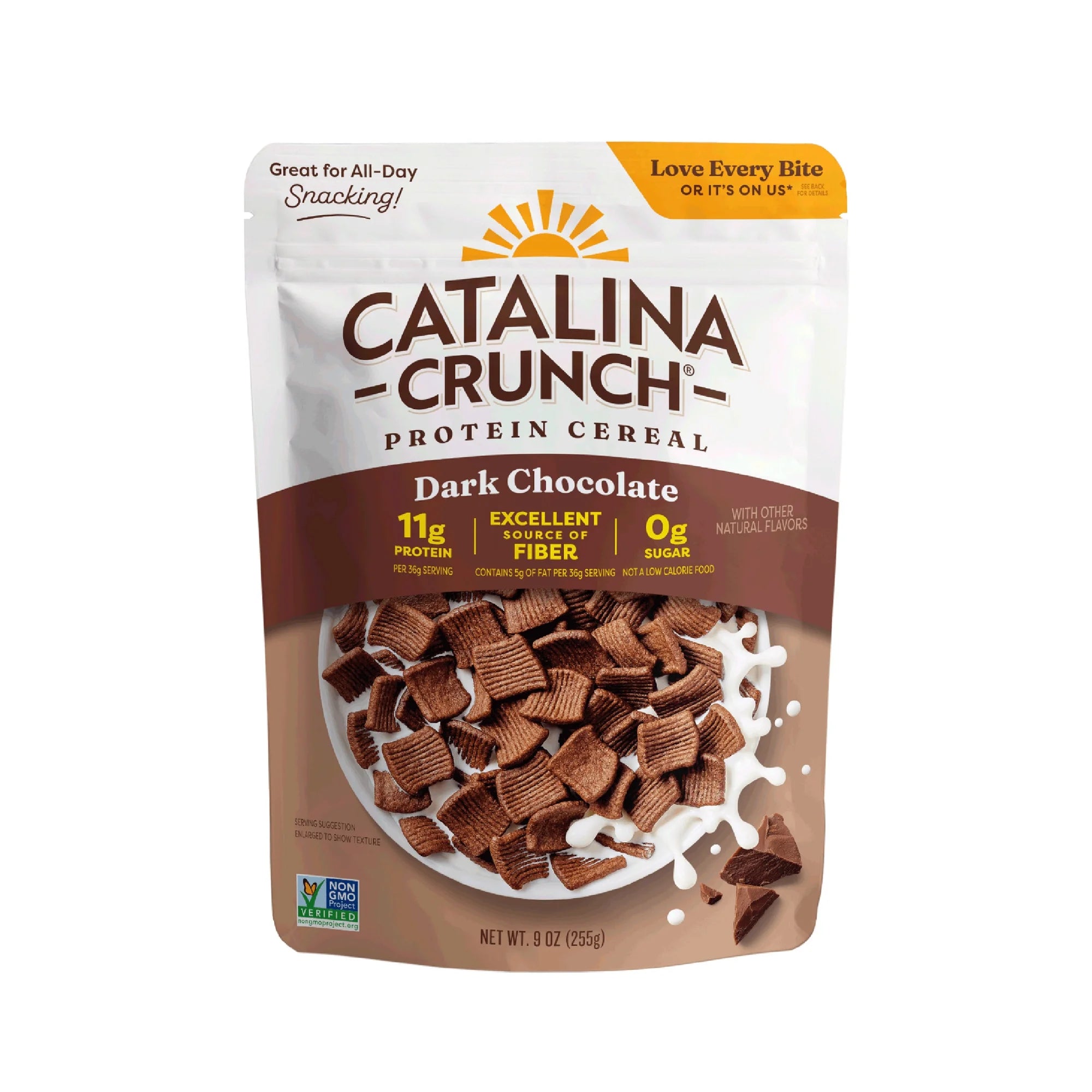 A bag of Catalina Crunch Dark Chocolate protein cereal displays the product name, nutritional highlights, and a splash of white milk, emphasizing its high protein and fiber content.