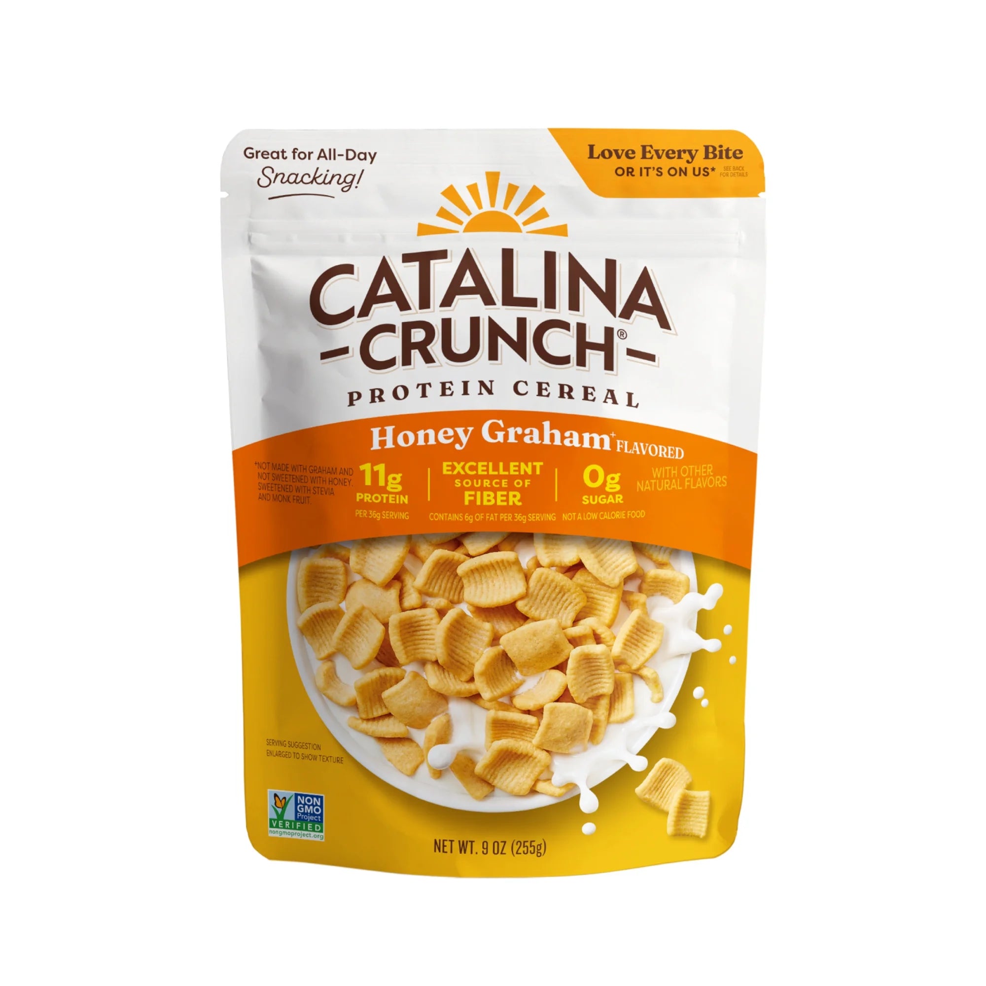 A bag of Catalina Crunch Honey Graham flavored protein cereal displays a bright design with cereal pieces spilling out, highlighting its high protein and fiber content, and no added sugar.
