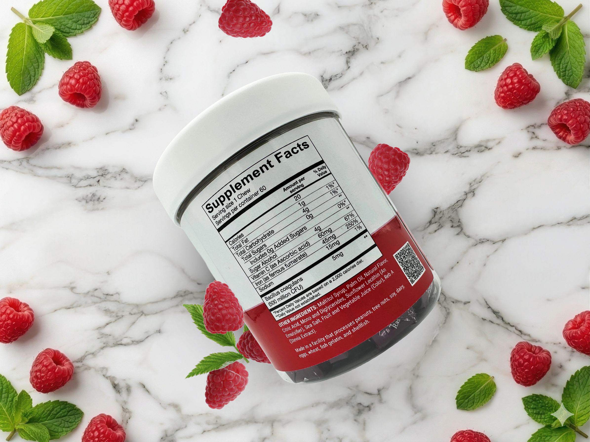 A clear supplement jar labeled "Supplement Facts" sits on a marble surface, surrounded by fresh raspberries and mint leaves, highlighting its fruity flavor and nutritional information.