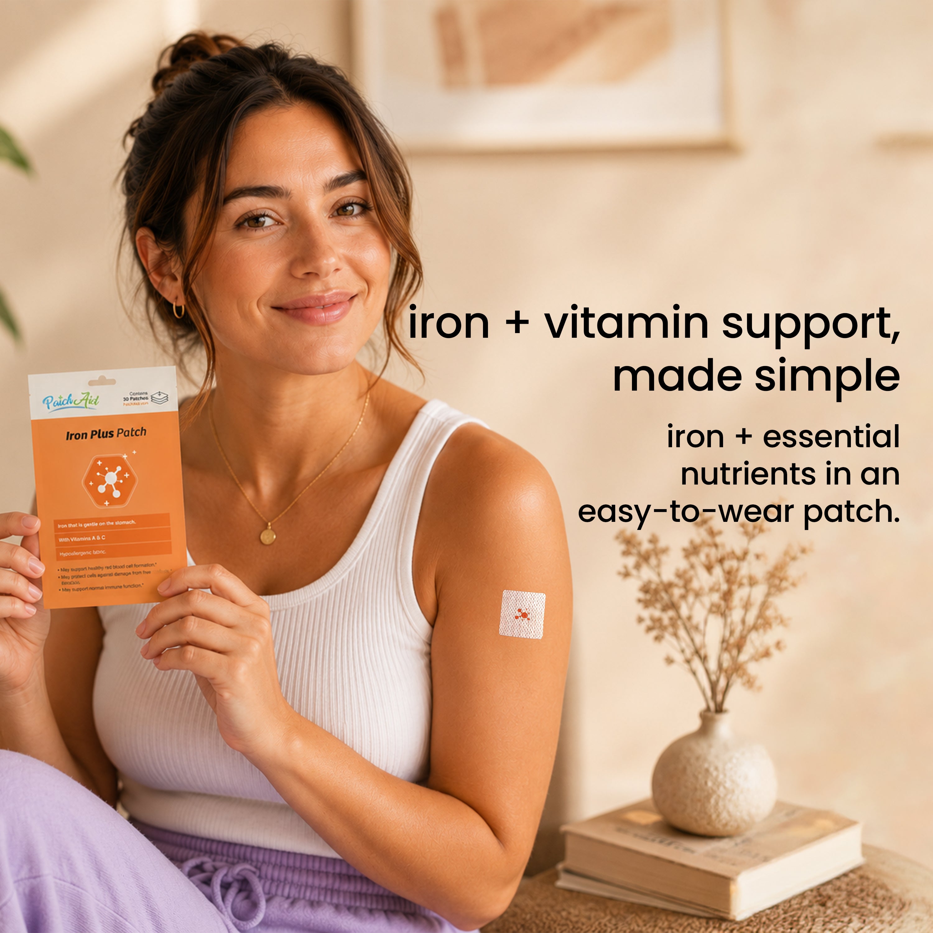 Woman wearing a PatchAid Iron Plus Patch on her upper arm while holding the 30-patch package. Provides iron and essential nutrients in an easy-to-wear patch.